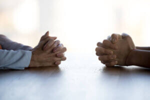 Two individuals negotiating credit card debt at a table